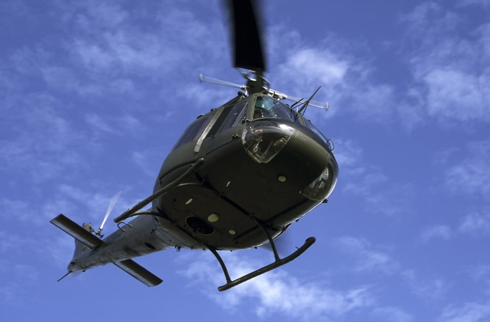 Former US Air Force Bell UH-1E Huey helicopter in flight Canvas Art - Daniel KarlssonStocktrek Images (35 x 23)