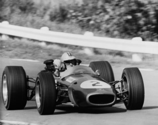 Formula one race car moving on a track Canvas Art - (24 x 36)