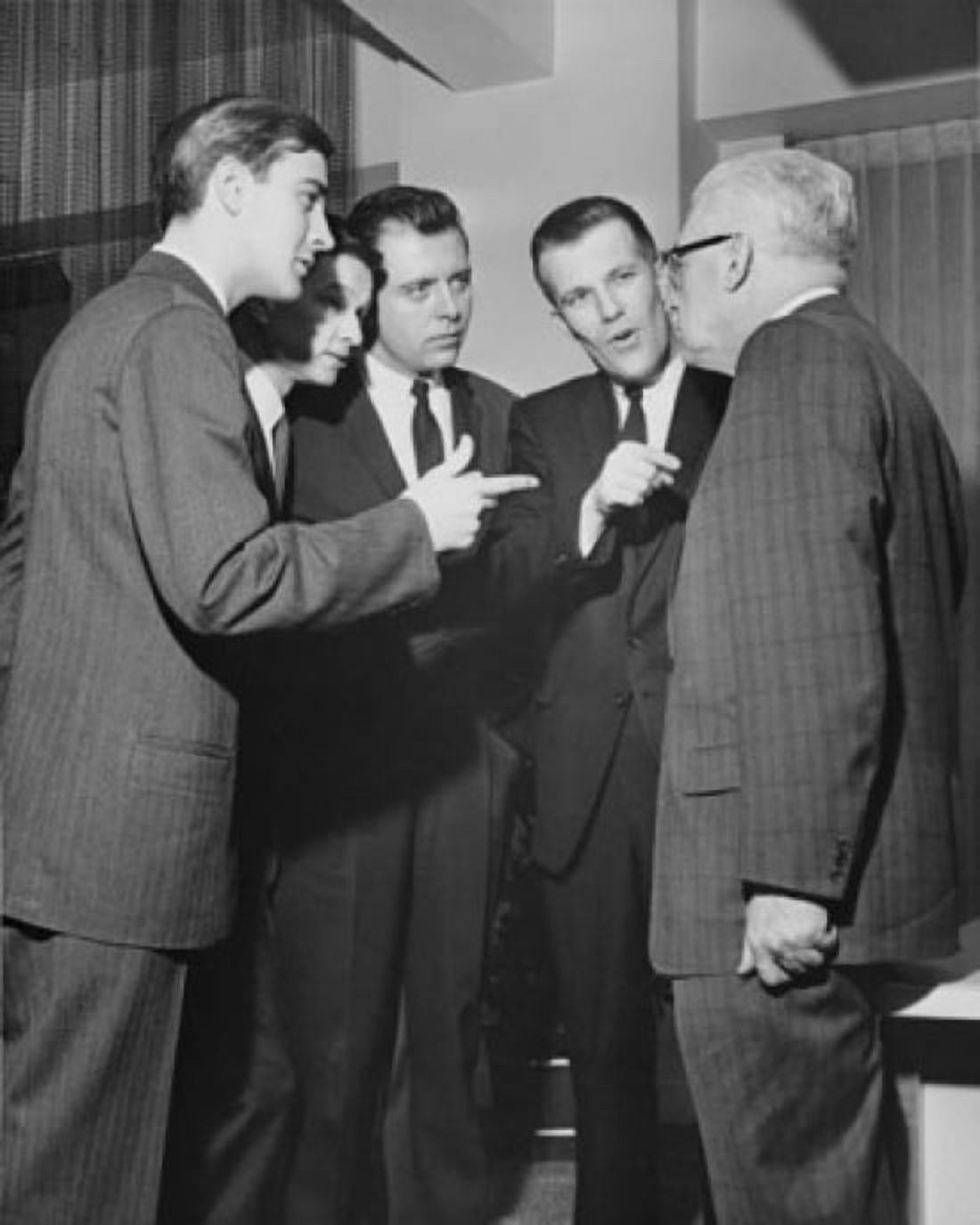 Four businessmen pointing at another businessman Canvas Art -  (24 x 36)