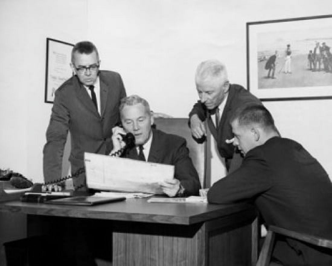Four businessmen reviewing document in office Canvas Art -  (18 x 24)