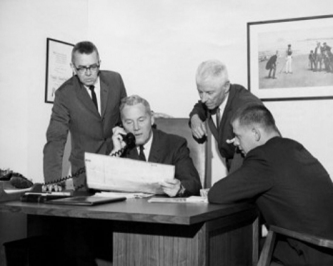Four businessmen reviewing document in office Canvas Art - (24 x 36)