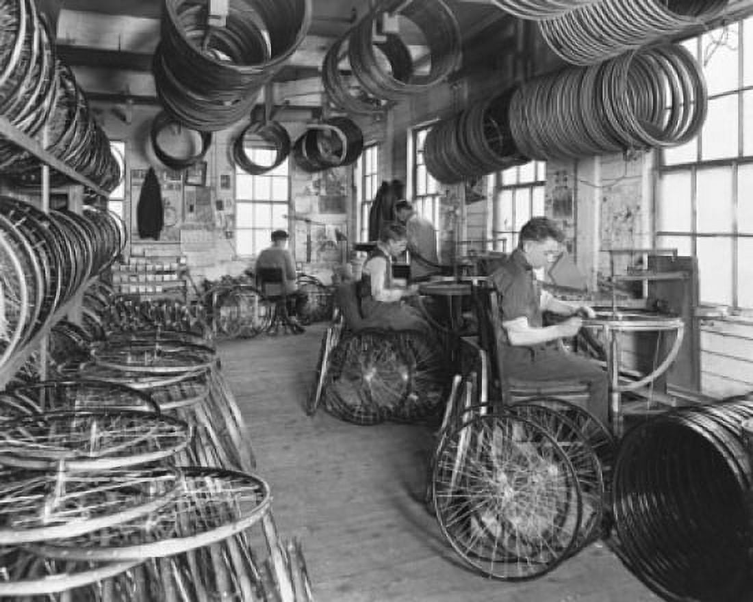 Four manual workers manufacturing bicycles in a factory Canvas Art - (18 x 24)