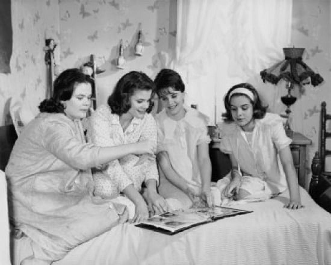 Four teenage girls looking at a photo album Canvas Art - (24 x 36)