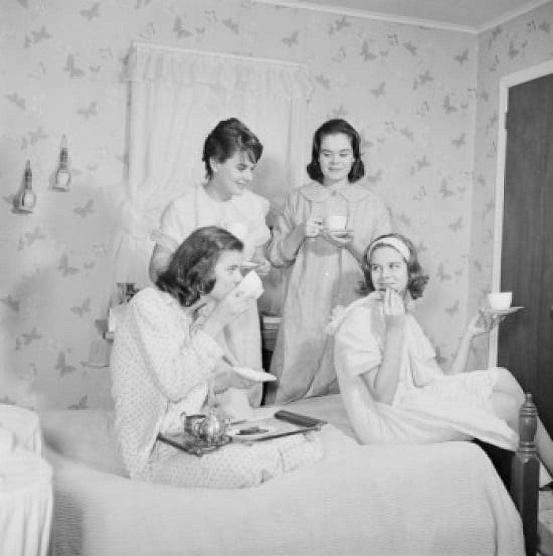 Four young women having pillow fight in bedroom Canvas Art - (24 x 36)
