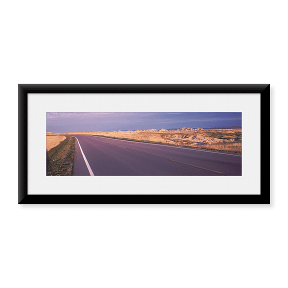 Framed Art Print, Road passing through the Badlands National Park by Panoramic Images, 25-7/8" x 9-7/8"