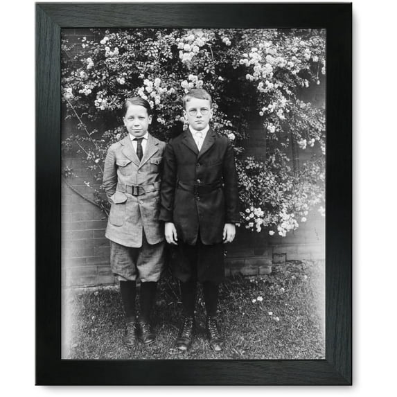 Framed Print: Two Boys Posed, Standing In Front Of Wall And Blooming Tree, circa