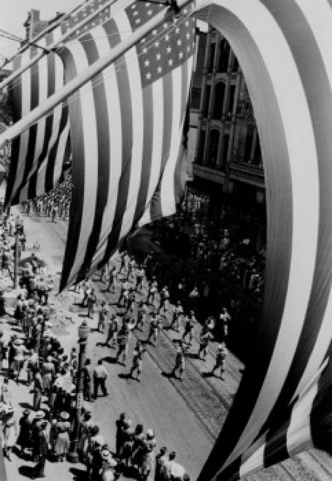Framing parade as seen through flags and poles Canvas Art - (18 x 24)