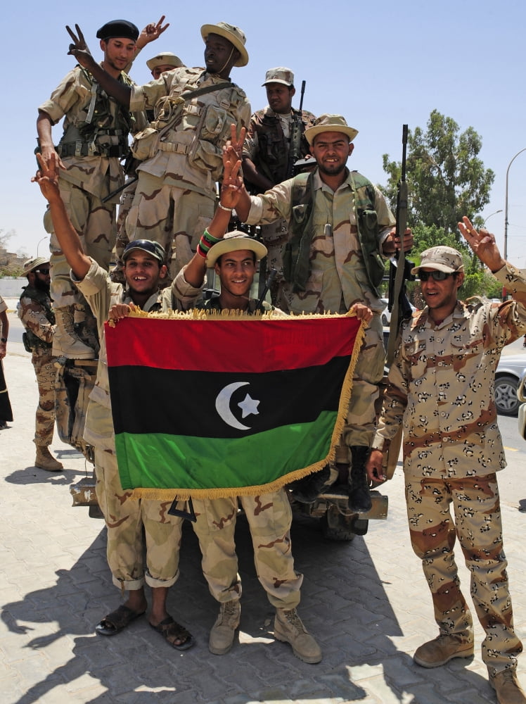 Free Libyan Army troops pose with the Flag of the National Transitional Council Canvas Art - Andrew ChittockStocktrek Images (25 x 33)