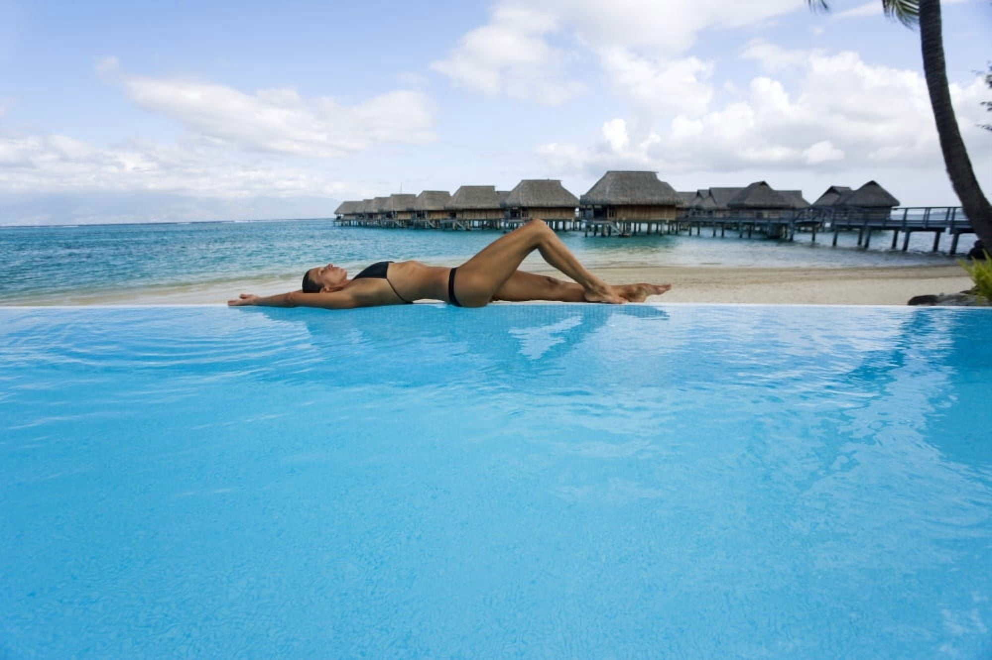 French Polynesia Moorea Woman Relaxing At Resort Poolside Luxury Resort Bungalows In Background Canvas Art - M Swiet Productions Design Pics (18 x 12)