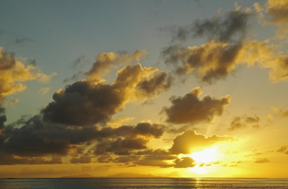 French Polynesia Raiatea Sun Shining Through Clouds Over The Ocean At Sunset Canvas Art - Kyle Rothenborg Design Pics (36 x 24)