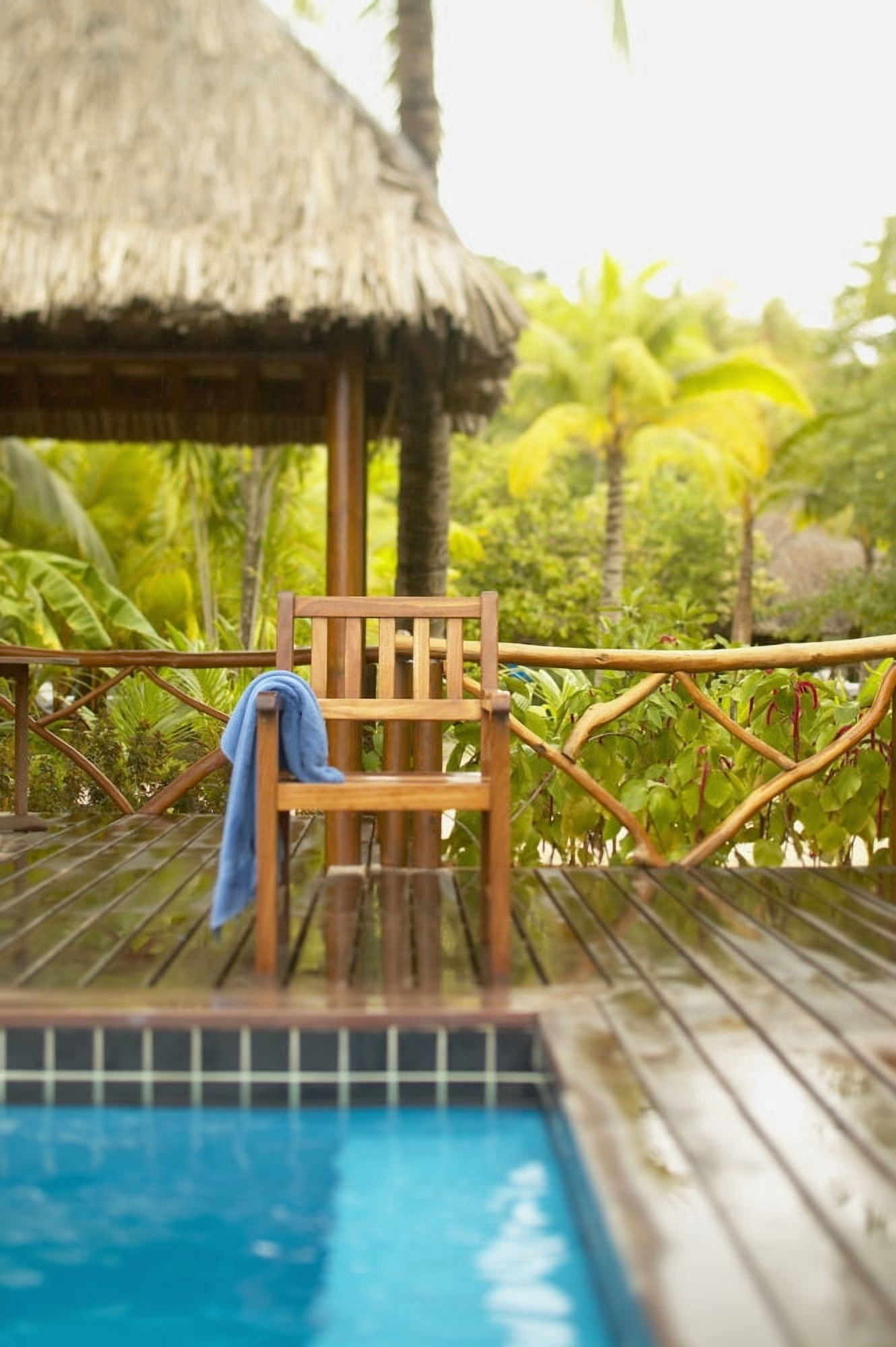 French Polynesia Tahiti Bora Bora Deck Chair With Towel Hanging Over It Next To Swimming Pool Tropical Vegetation Selective Focus Canvas Art - Kyle Rothenborg Design Pics (12 x 19)