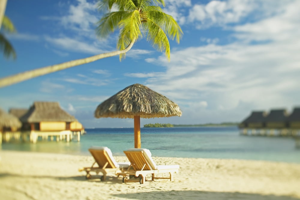 French Polynesia Tahiti Bora Bora Lounge Chairs And Thatch Umbrella On Beach With Tranquil Ocean And Bungalows Canvas Art - Kyle Rothenborg Design Pics (38 x 24)