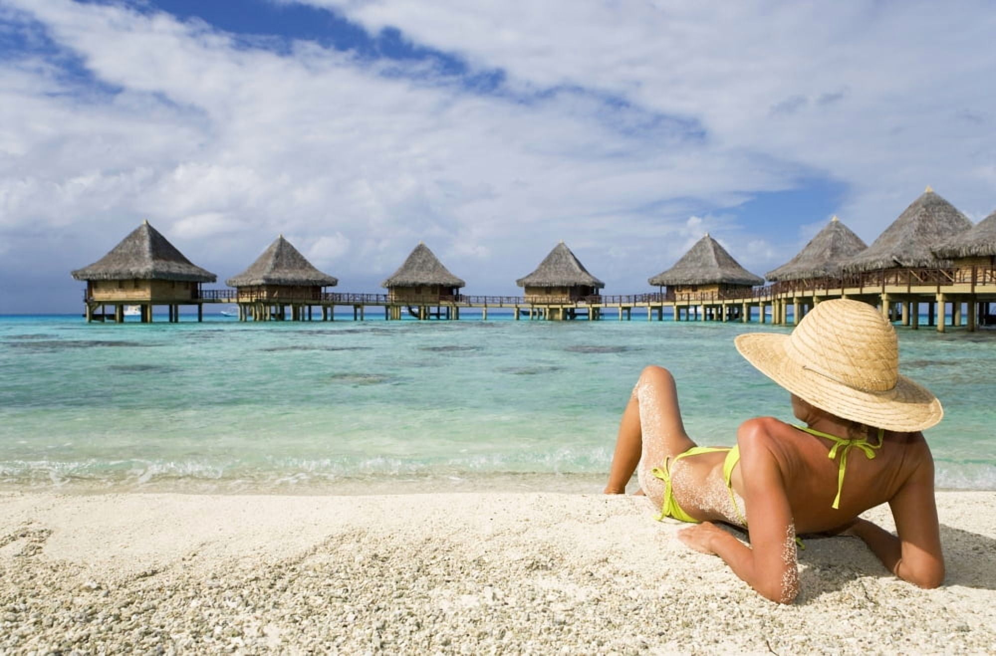 French Polynesia Tuamotu Islands Rangiroa Atoll Woman Lounging On Beach Luxury Resort Bungalows In Background Canvas Art - M Swiet Productions Design Pics (36 x 22)
