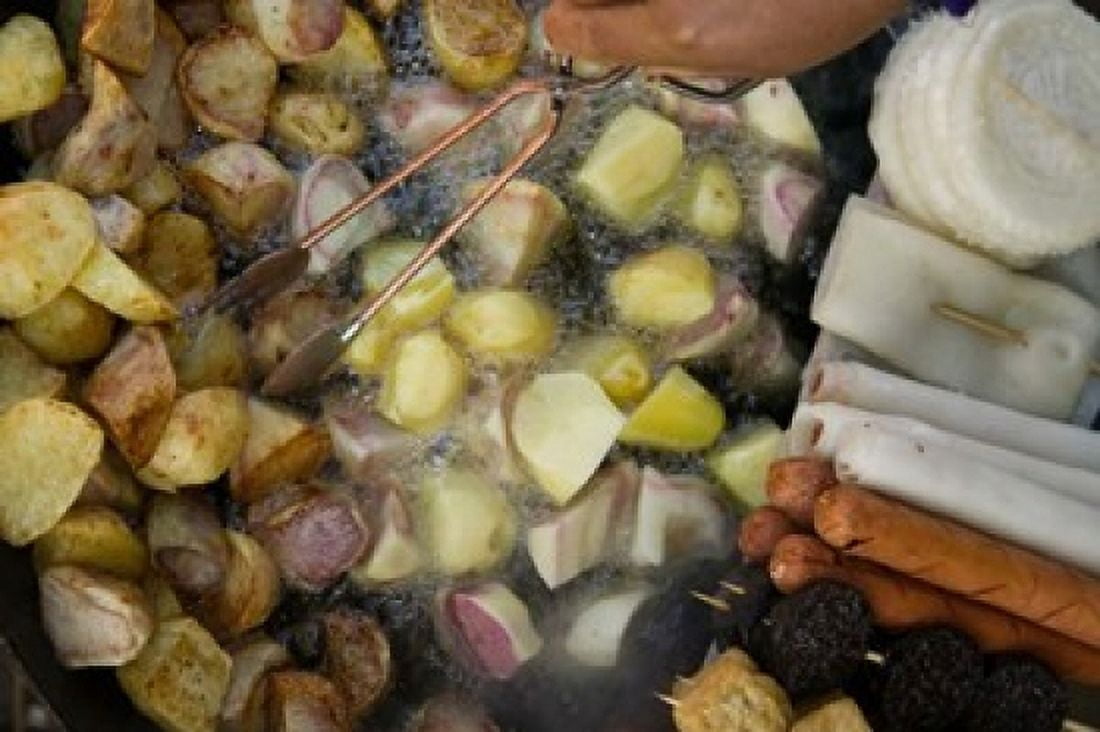 Fried potatoes and snacks on the grill in a street market Old Town Lijiang Yunnan Province China Canvas Art - Panoramic Images (36 x 24)