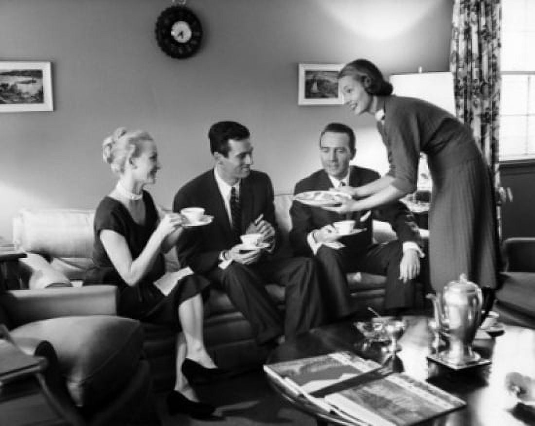Friends drinking tea and talking in living room Canvas Art - (24 x 36)