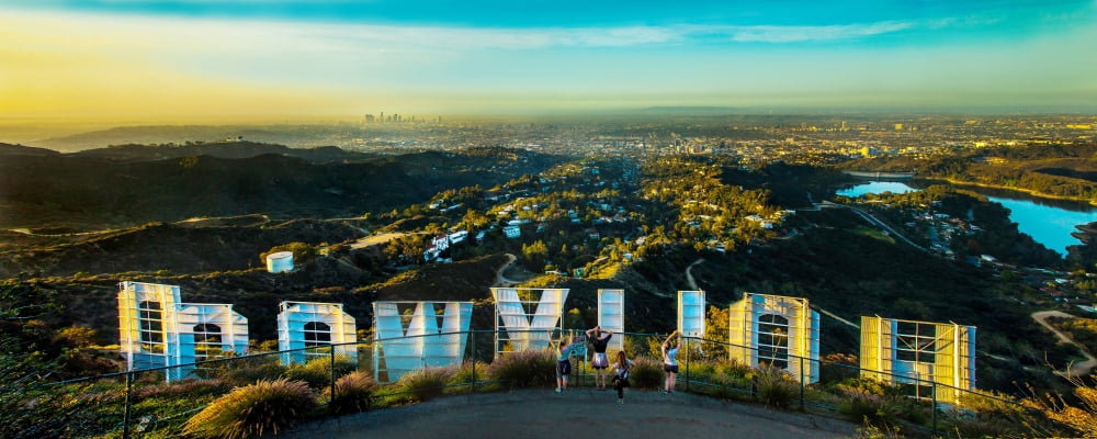 Friends taking pictures behind the Hollywood Sign City Of Los Angeles Los Angeles County California USA Canvas Art - Panoramic Images (12 x 30)