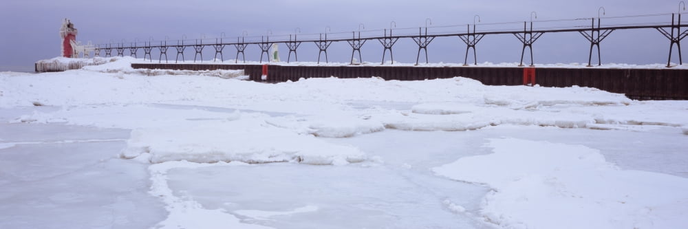 Frozen lake with a lighthouse in the background Lake Michigan St Joseph Michigan USA Canvas Art - Panoramic Images (36 x 12)