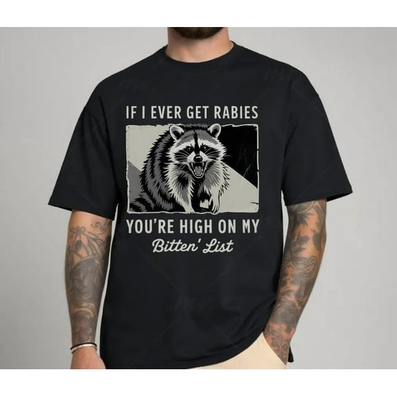 Funny Raccoon Graphic Tee – “Bitin' List” Dark Humor Shirt for Men and Women
