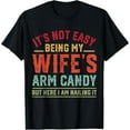 thumbnail image 1 of Funny Relationship Humor Graphic Tee, Tops Has "IT'S NOT EASY BEING MY WIFE'S ARM CANDY BUT HERE I AM NAILING IT" Text Design, Round Neck Regular Fit T - shirts, Size(S - 5XL), 1 of 5