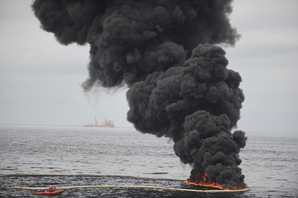 Gathered concentrated oil burns during a controlled oil fire in the Gulf of Mexico Canvas Art - Stocktrek Images (34 x 23)