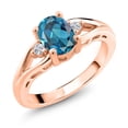 thumbnail image 1 of Gem Stone King 18K Rose Gold Plated Silver London Blue Topaz and White Lab Grown Diamond 3 Stone Engagement Ring for Women | 1.58 Cttw | Oval 8X6MM | Round 2MM | Gemstone November Birthstone | Size 8, 1 of 6
