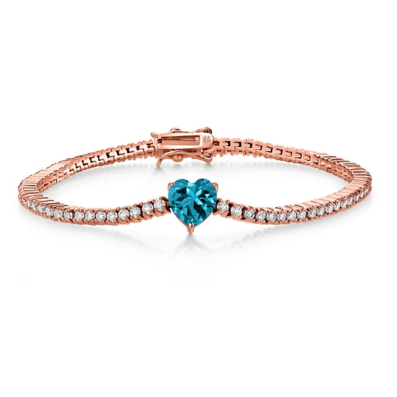 Gem Stone King 18K Rose Gold Plated Silver London Blue Topaz and White Moissanite Tennis Bracelet for Women (5.08 Cttw, Gemstone Birthstone, Heart Shape 8MM, 7.25 inch)
