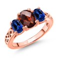 thumbnail image 1 of Gem Stone King 18K Rose Gold Plated Silver Red Garnet and Blue Created Sapphire Filigree Style 3 Stone Ring for Women (2.73 Cttw, Oval 8X6MM and 6X4MM) (Size 6), 1 of 6
