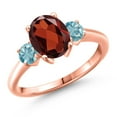 thumbnail image 1 of Gem Stone King 18K Rose Gold Plated Silver Red Garnet and Blue Zircon Engagement Ring for Women | 3.13 Cttw | Oval 9X7MM | Gemstone January Birthstone | Size 6, 1 of 6