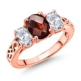 thumbnail image 1 of Gem Stone King 18K Rose Gold Plated Silver Red Garnet and White Topaz Filigree Style 3 Stone Ring for Women (2.73 Cttw, Oval 8X6MM and 6X4MM) (Size 8), 1 of 6