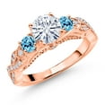 thumbnail image 1 of Gem Stone King 18K Rose Gold Plated Silver White Moissanite and Swiss Blue Topaz Engagement Ring for Women (1.37 Cttw, Gemstone, Round 6MM and 3MM, Size 5), 1 of 4