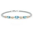 thumbnail image 1 of Gem Stone King 925 Silver and 10K Yellow Gold Blue Zircon and White Lab Grown Diamond Bracelet for Women (2.61 Cttw, Gemstone, Oval, Wheat Chain, 7.5 inches), 1 of 5