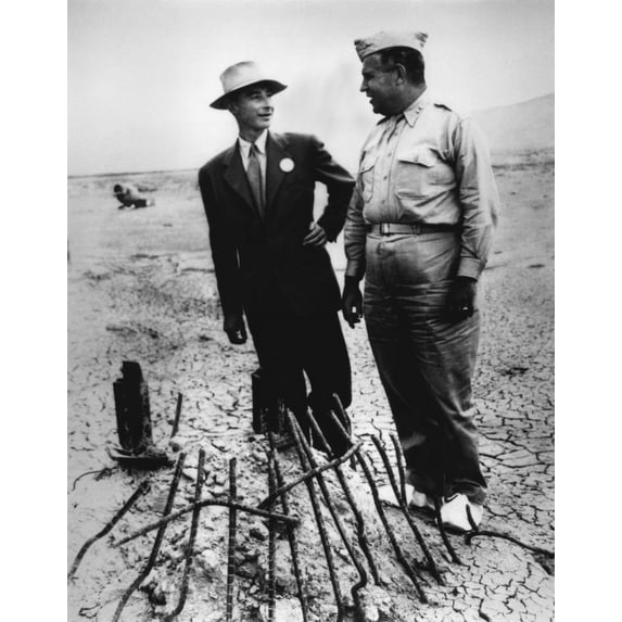 Gen. Leslie Groves (R) And Dr. J. Robert Oppenheimer At Trinity Test Site In Sept. 1945. They Examine The Remains Of The Tower From Which The First Manmade Atomic Explosion Was Detonated Near