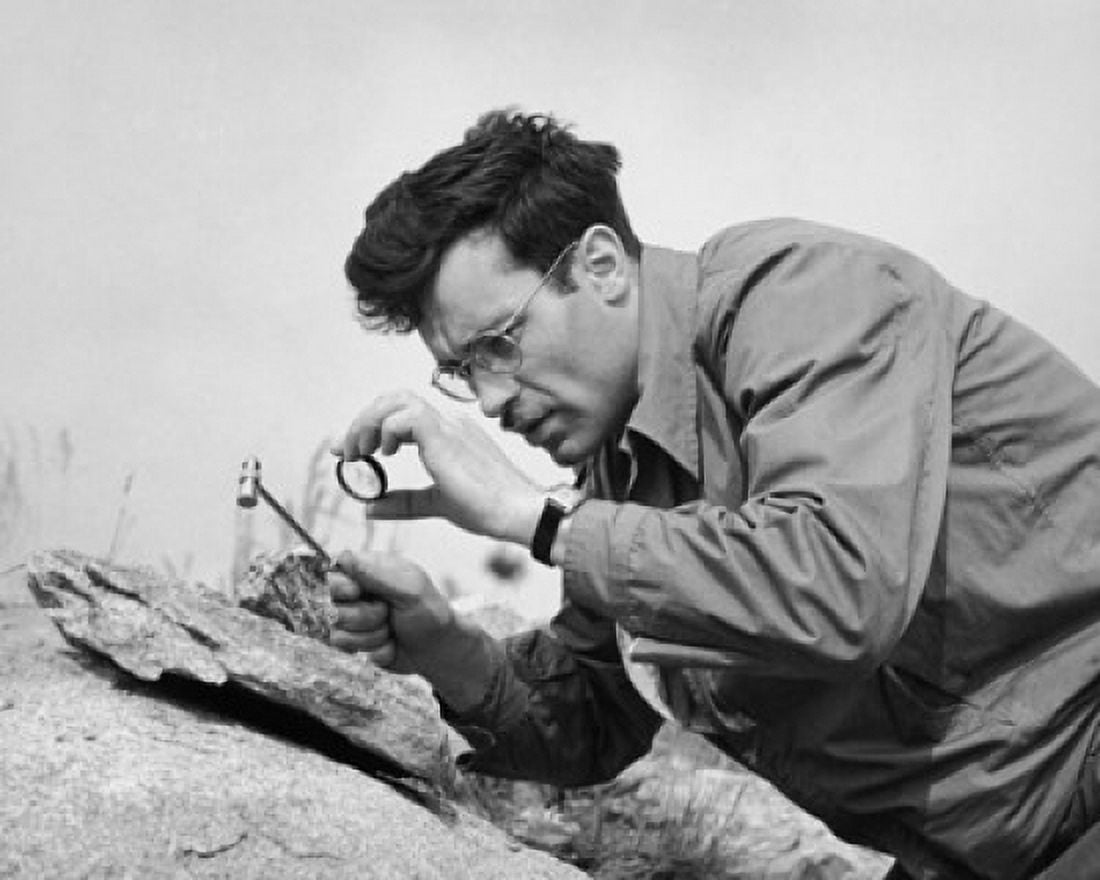 Geologist looking at a rock through a magnifying glass Canvas Art - (18 x 24)
