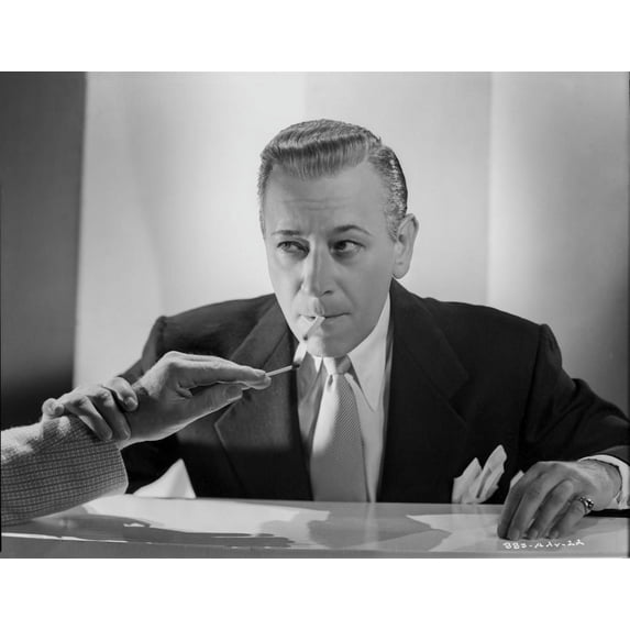 George Raft in Black Suit Lighting a Cigarette Photo Print (24 x 30)