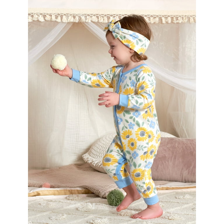 Bright Spring Jumpsuits For Newborns Hang On Hangers In A