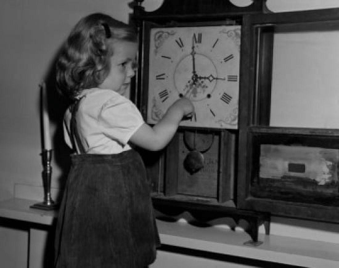 Girl adjusting clock Canvas Art -  (24 x 36)