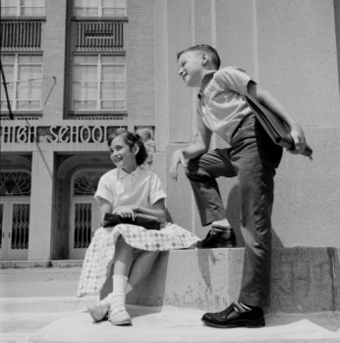 Girl and boy standing in front of school and smiling Canvas Art - (24 x 36)