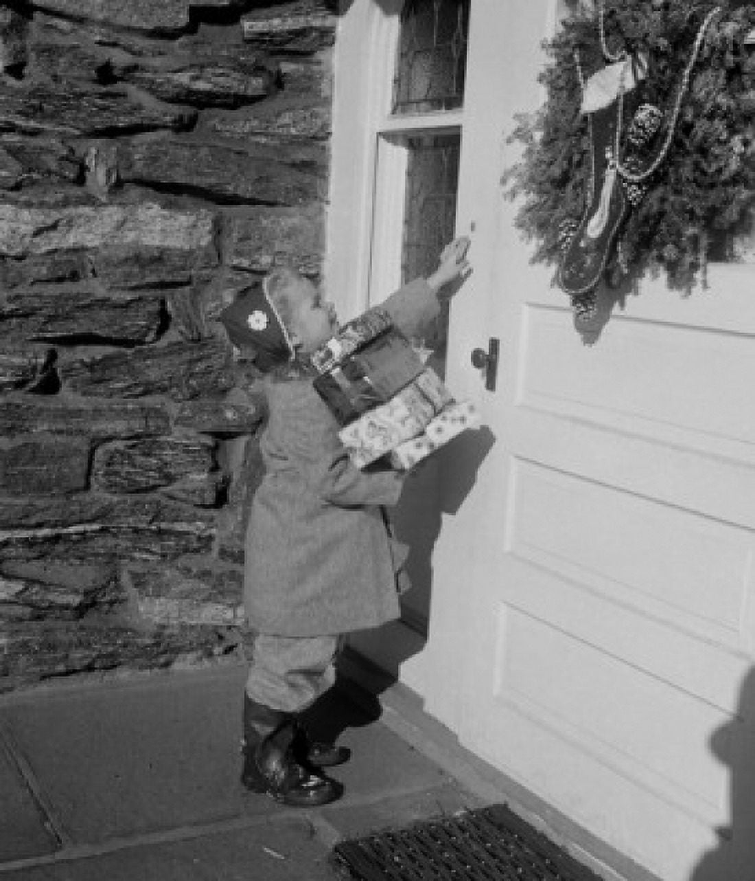 Girl carrying Christmas gifts and ringing door bell Canvas Art - (24 x 36)