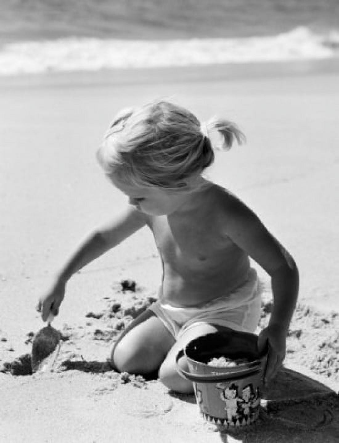 Girl digging sand on beach Canvas Art - (18 x 24)
