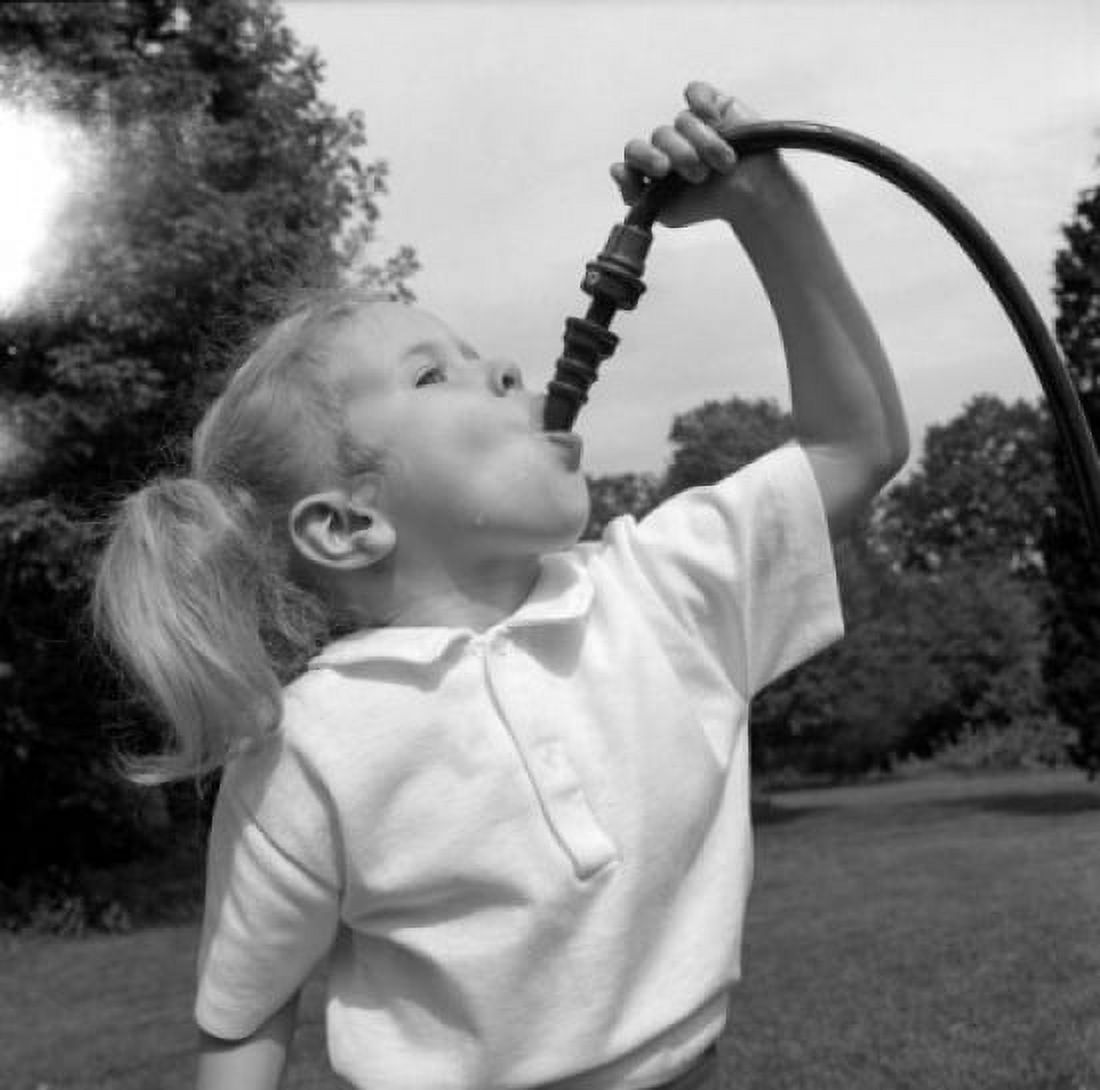 Girl drinking from garden hose Poster Print (18 x 24)