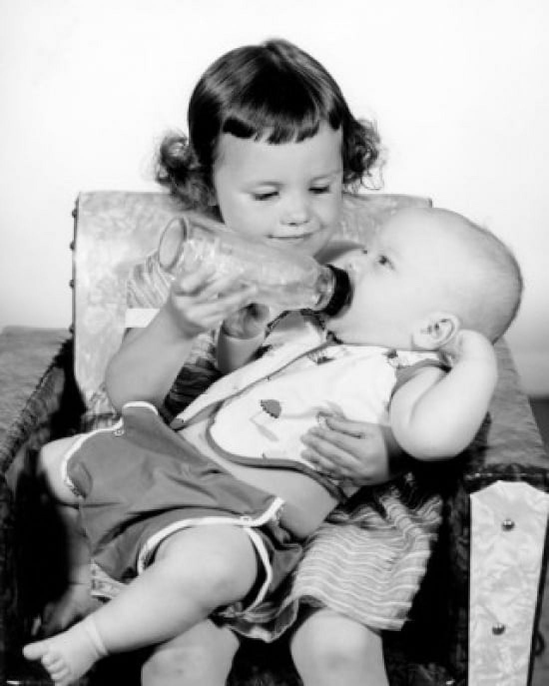 Girl feeding baby brother with dummy Canvas Art - (18 x 24)
