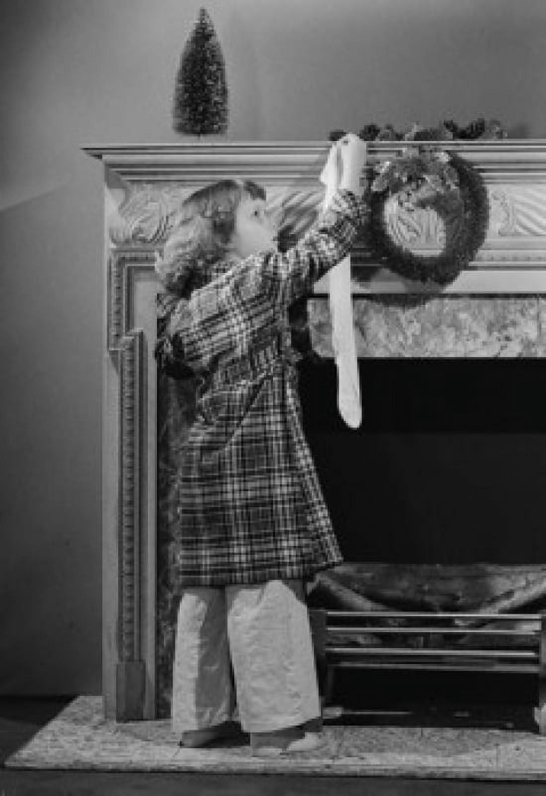 Girl hanging Christmas stocking on mantelpiece Canvas Art - (24 x 36)