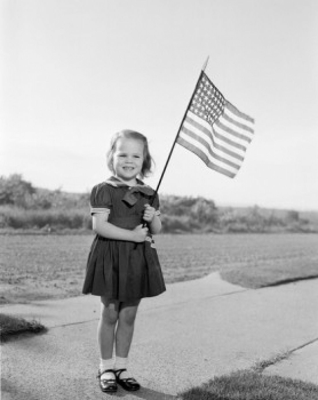 Girl holding US flag Canvas Art - (18 x 24)