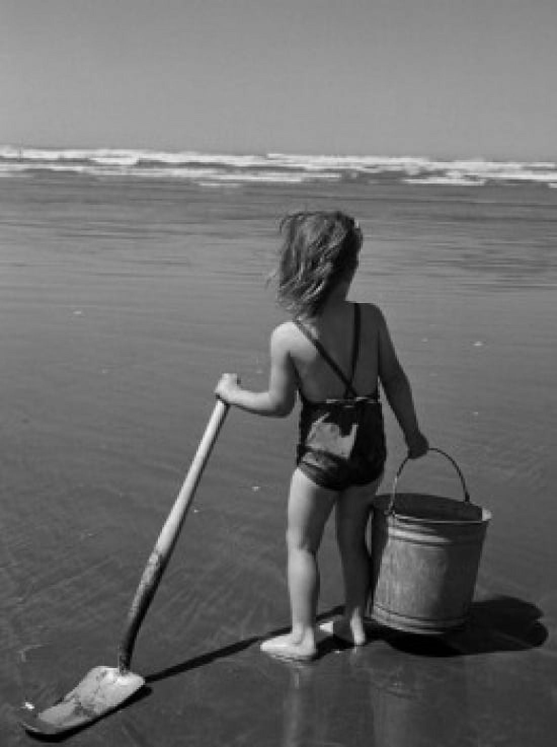 Girl holding bucket and spade on beach Canvas Art - (18 x 24)