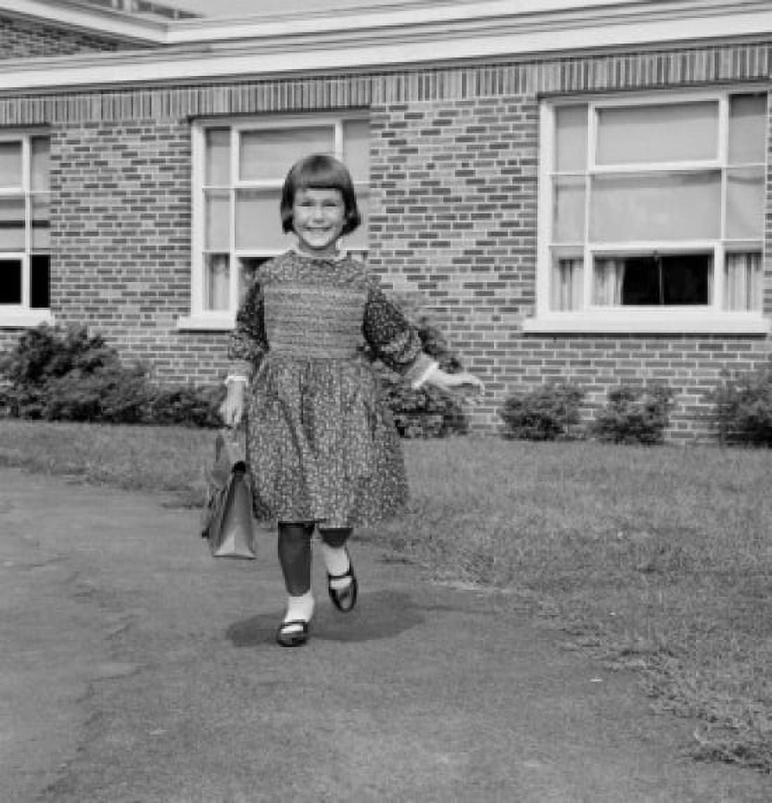Girl holding schoolbag walking school in background Canvas Art - (24 x 36)