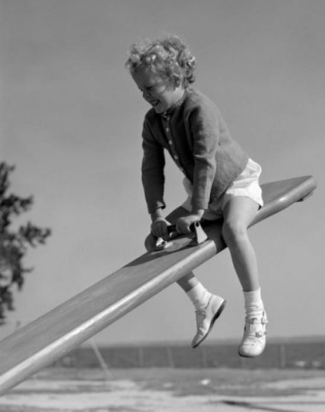 Girl on seesaw in playground Canvas Art - (18 x 24)