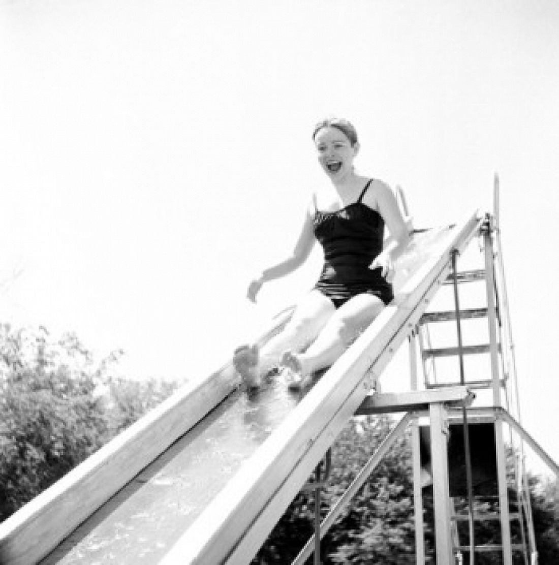 Girl on water slide in park Canvas Art - (18 x 24)