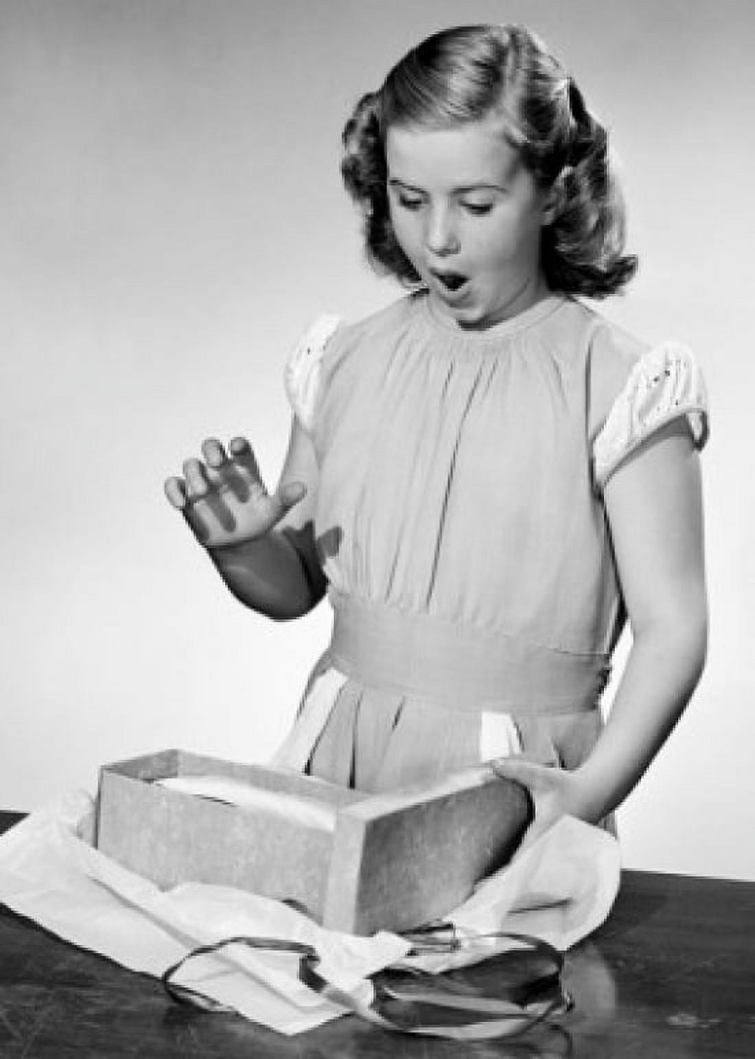 Girl opening present at table Canvas Art - (18 x 24)