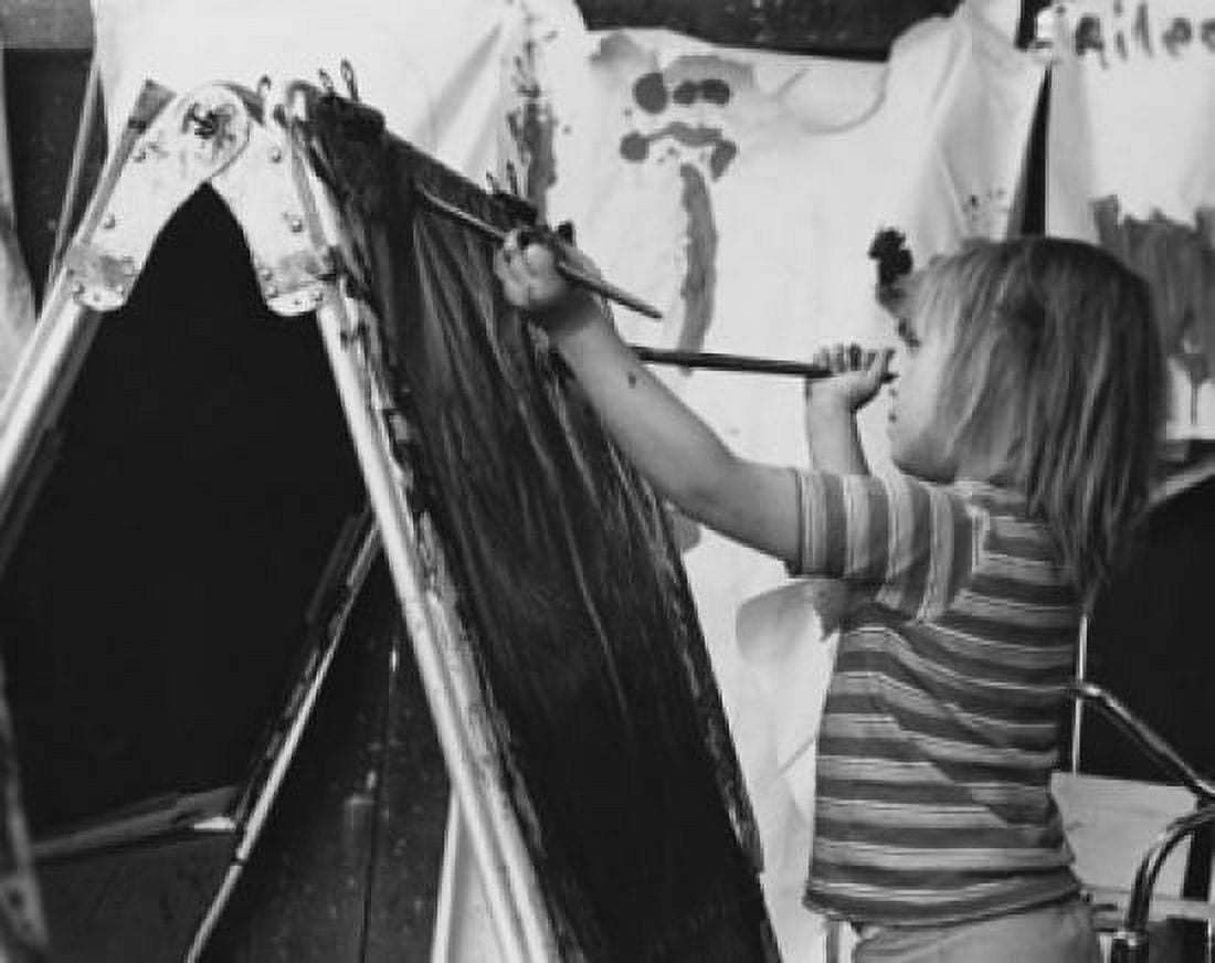 Girl painting on an easel Canvas Art - (18 x 24)