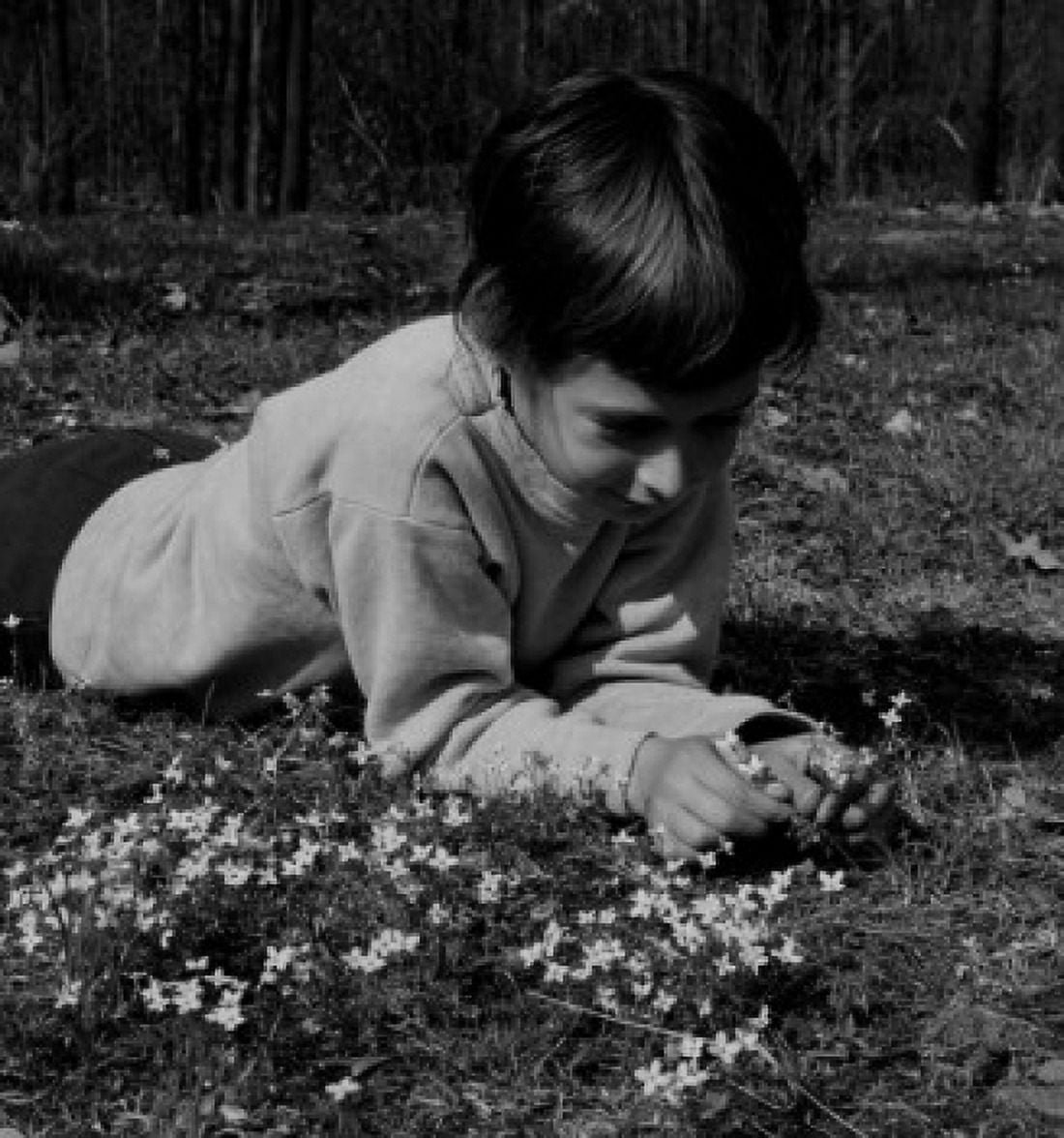 Girl picking flowers in field Canvas Art -  (24 x 36)